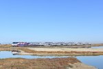 San Jose Diridon bound ACE Train # 07 finishes clearing the long causeway over the bad just before entering the Alviso Section of San Jose and crossing Elizabeth St at grade. A very interesting lashup of power is leading-an F40PH-3C with a SC-44 unit. 